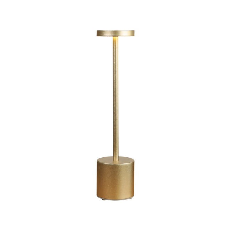 Retro bar table lamp with gold cylindrical base and slim vertical pole
