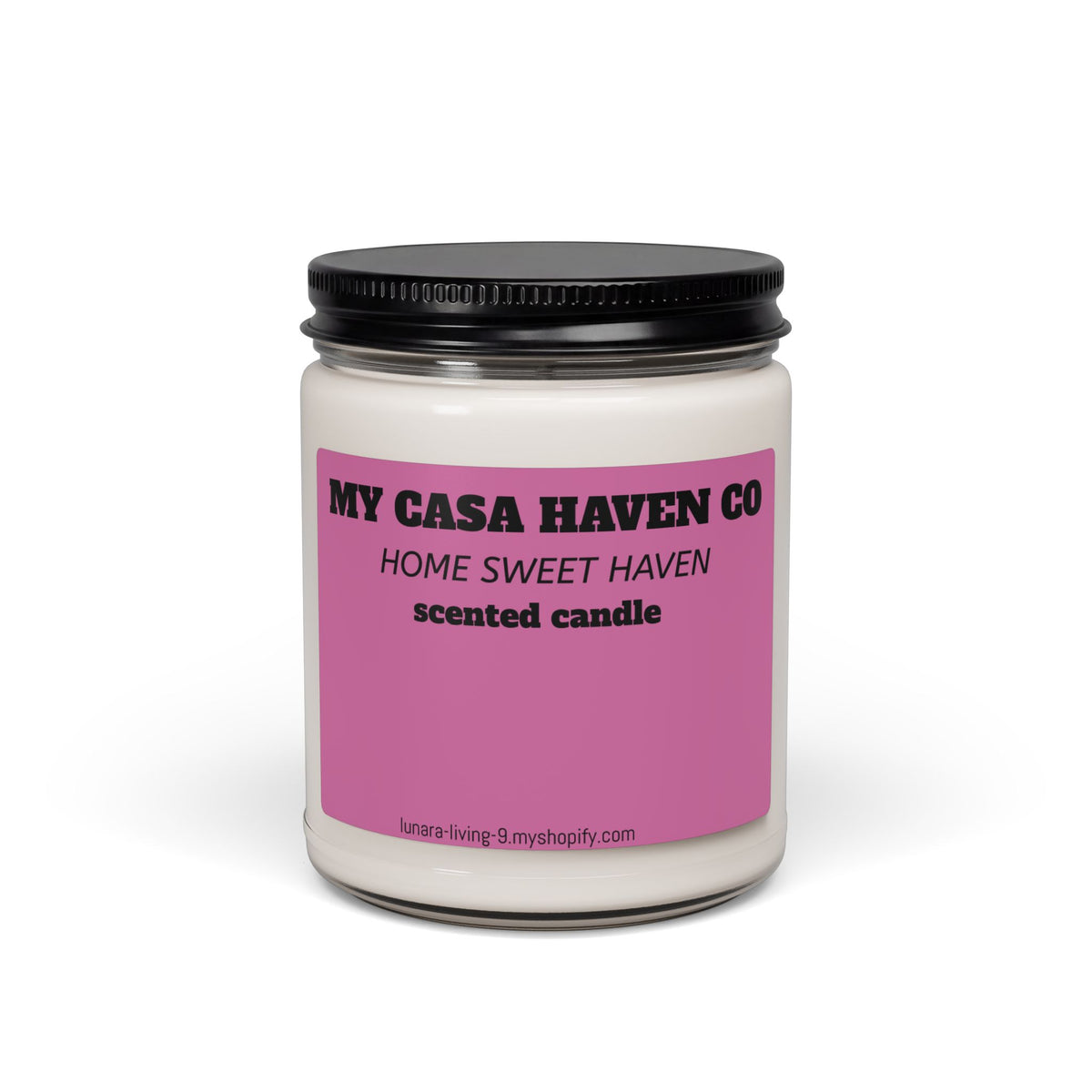 Scented soy candle in clear glass jar with black screw lid, purple label