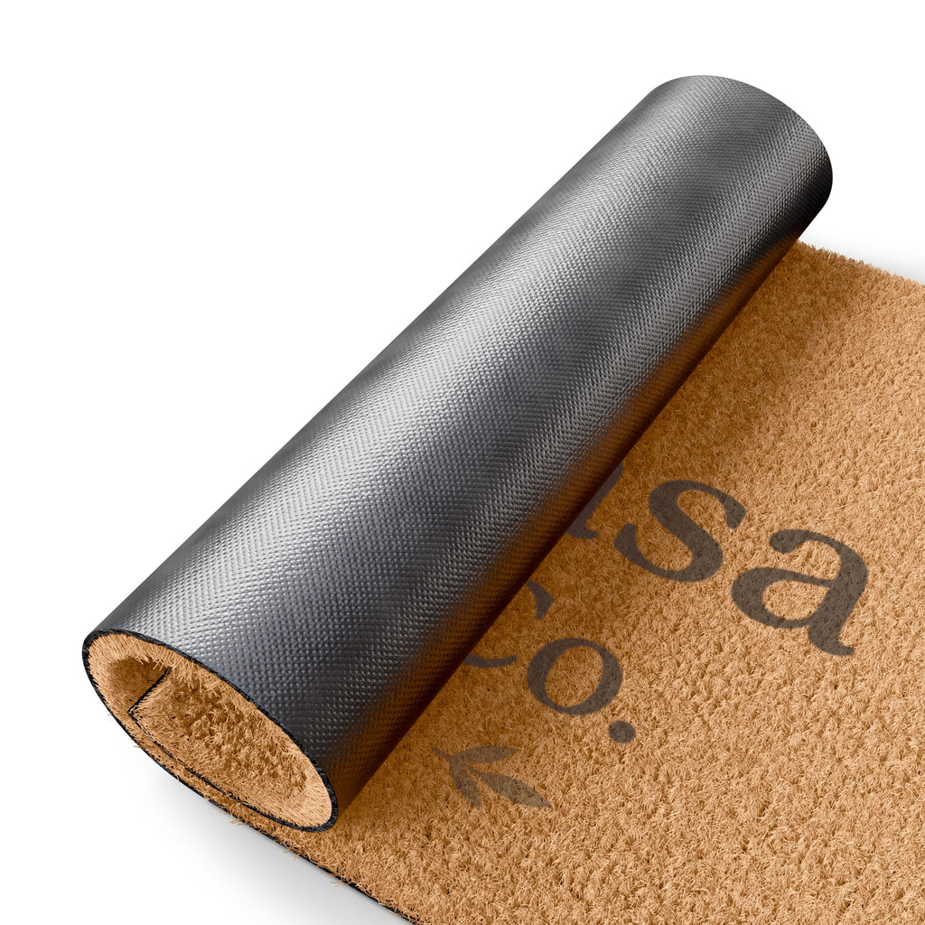 Rolled tan coir doormat with gray backing and 'My Casa Haven Co.' print