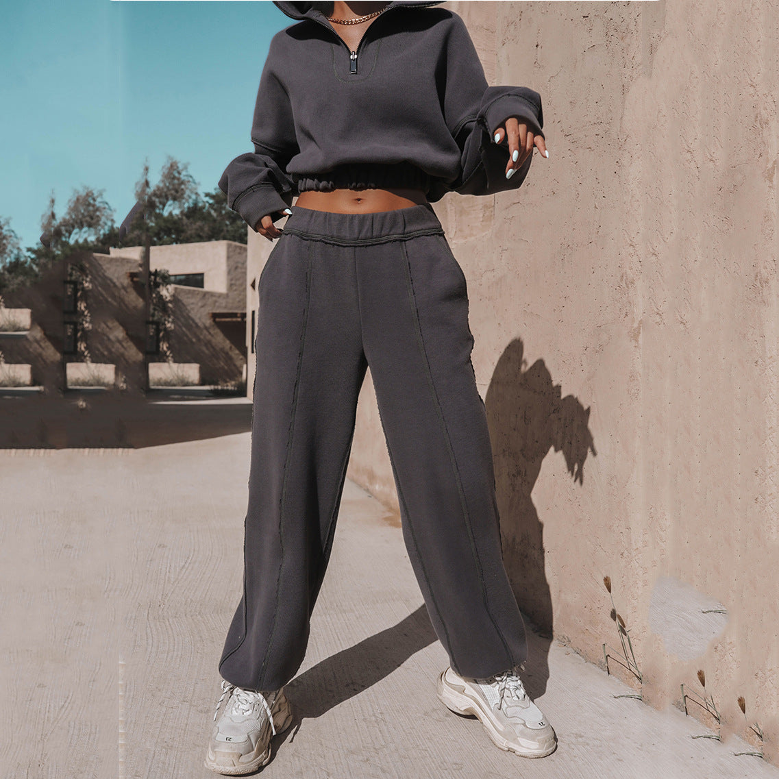 Dark charcoal quarter-zip hoodie and wide-leg jogger pants set with elastic waistband