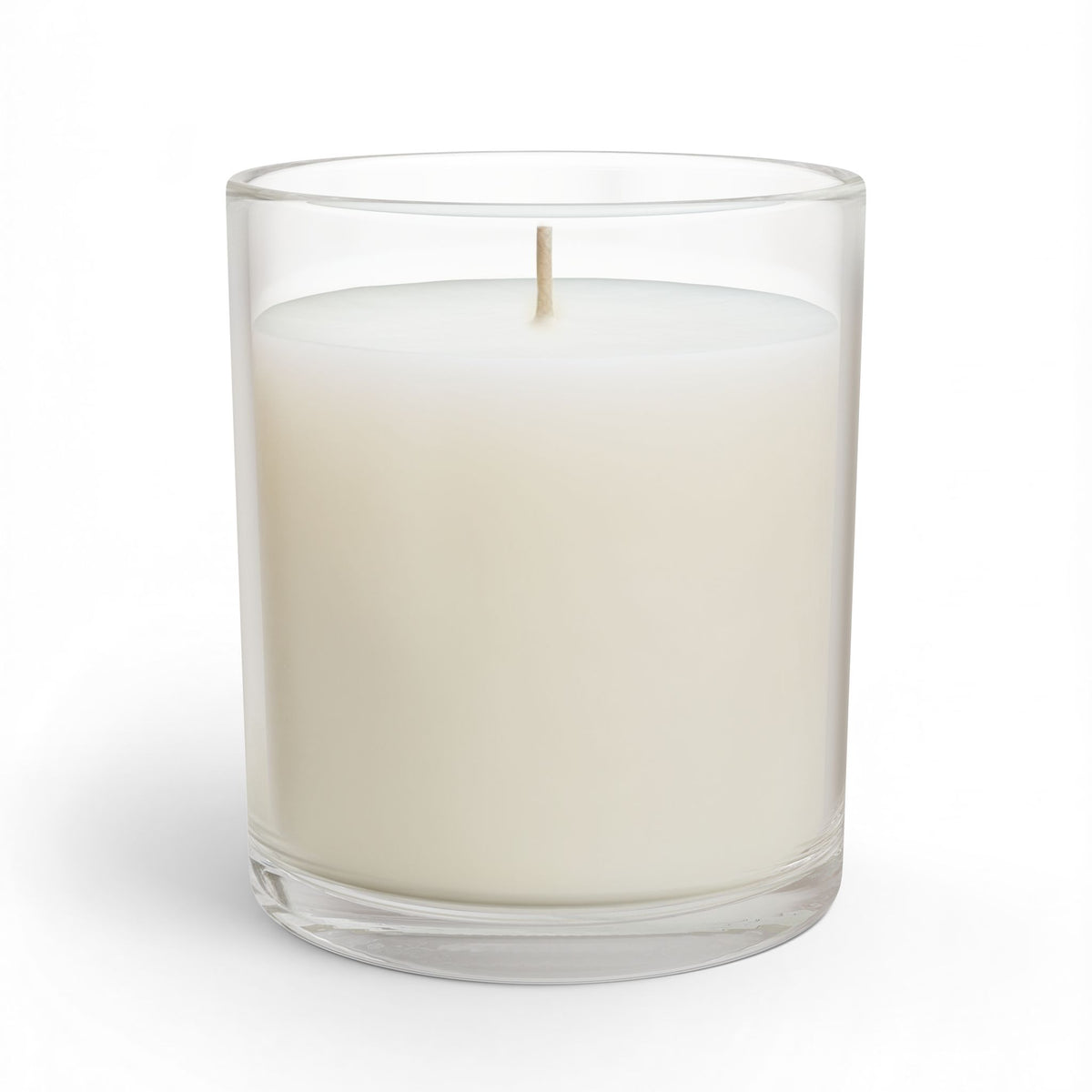 Glass candle in clear jar with creamy white wax and lit wick, smooth front