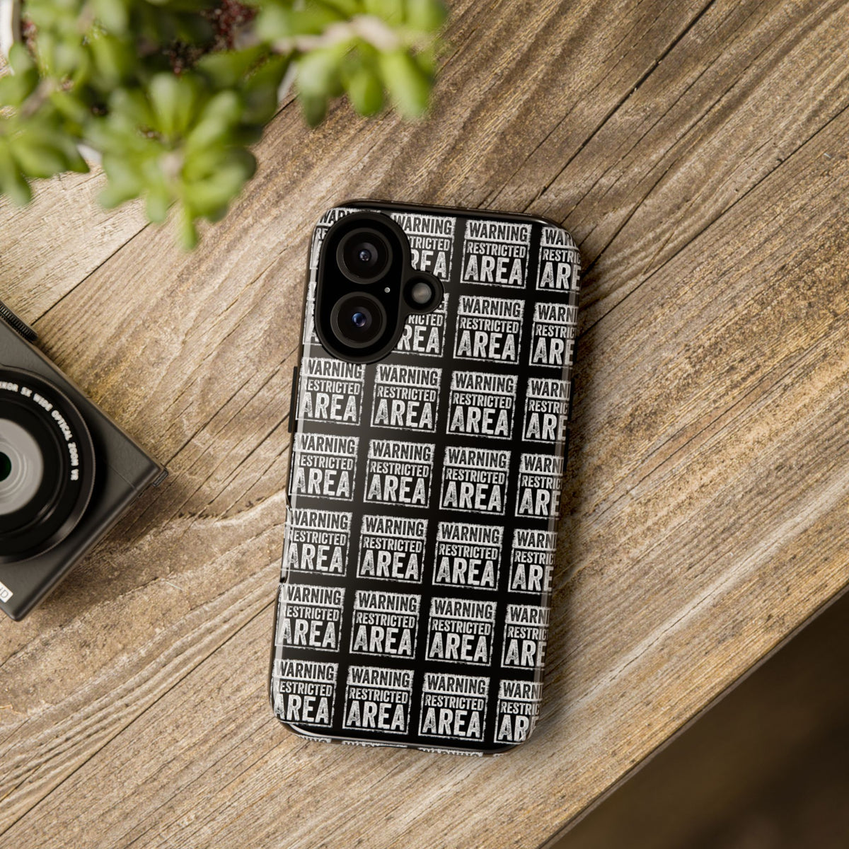 Black phone case with white warning text print and dual camera cutouts