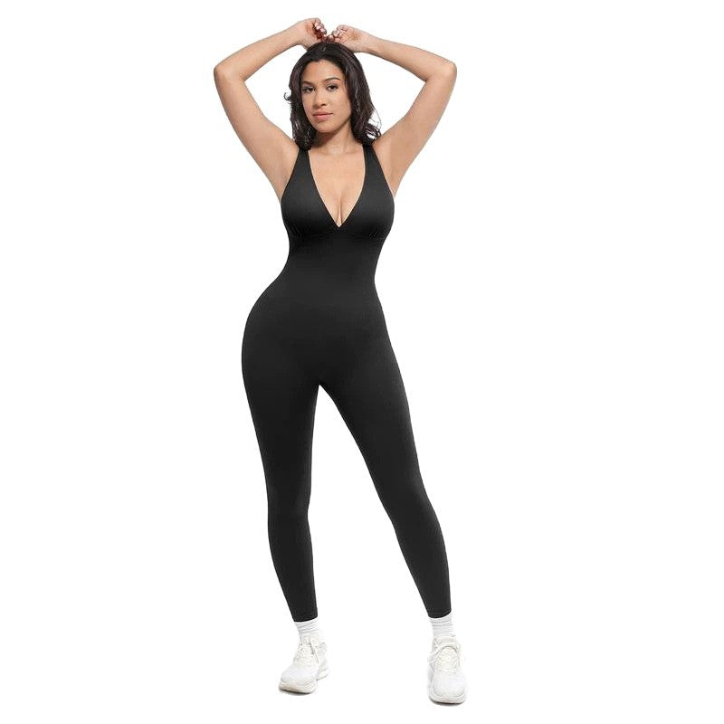 Black women's sleeveless V-neck jumpsuit with long fitted legs, arms raised overhead