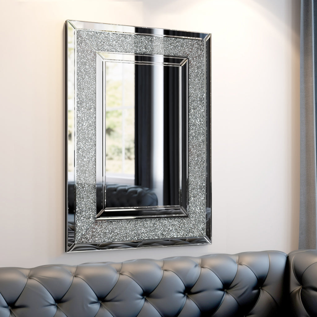 Rectangular wall mirror with glittering silver frame and reflective glass panel.