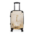 Cream suitcase with gold 'L' graphic, telescopic handle, and spinner wheels, black trim