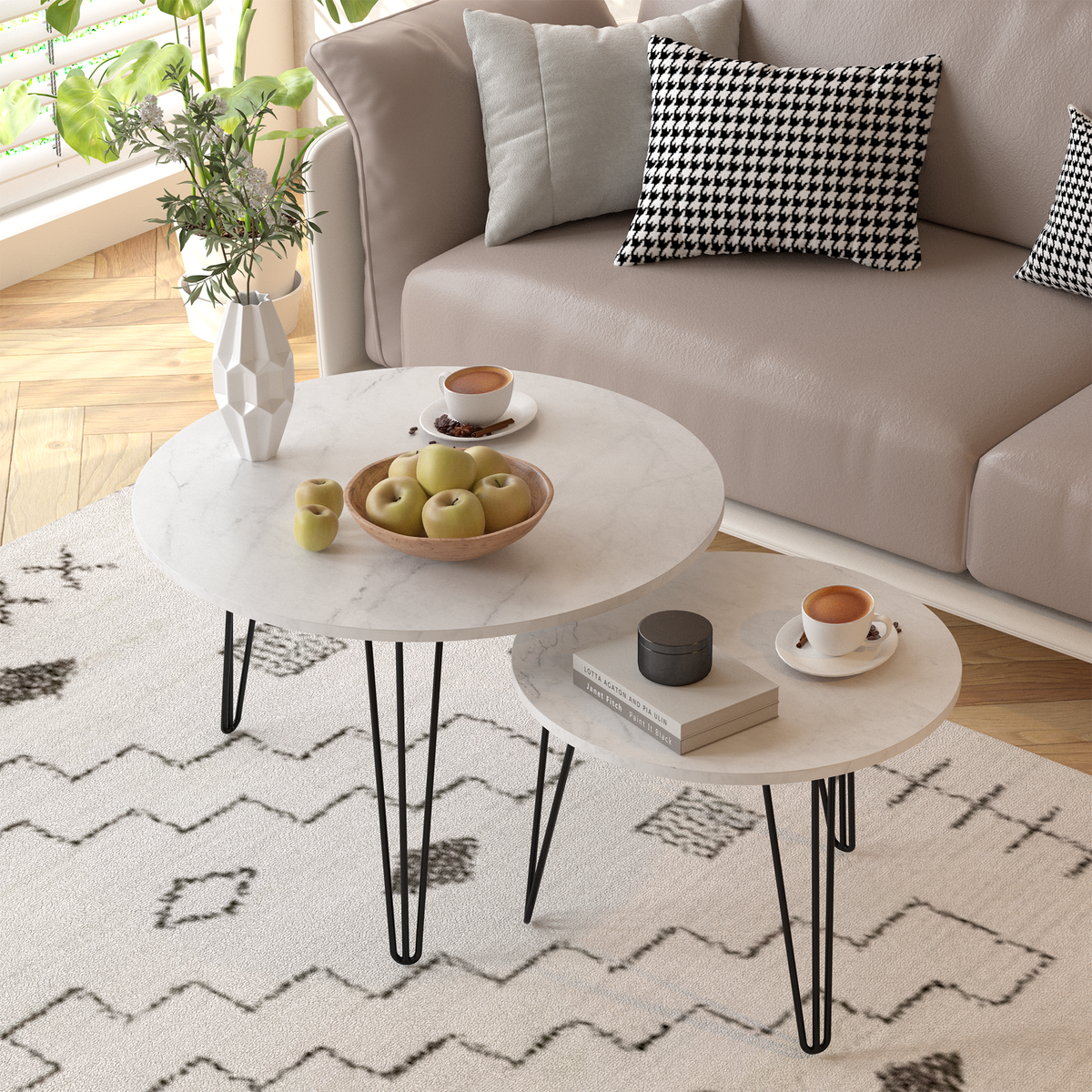 Round nesting coffee table set of 2 with white tops and black tapered metal legs