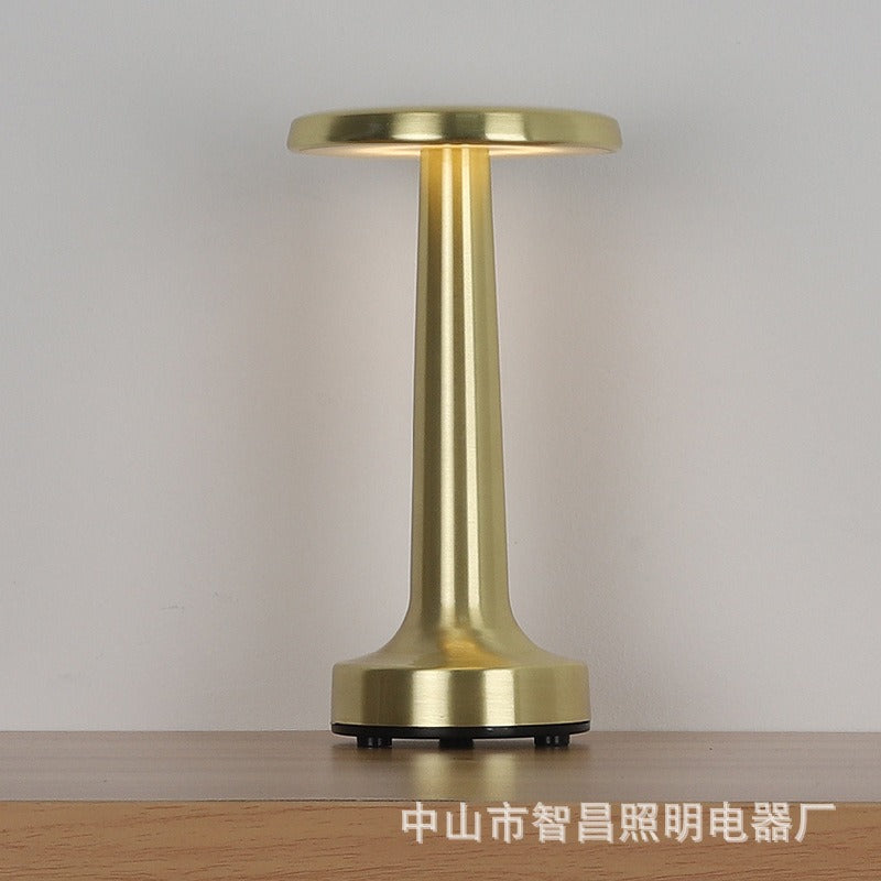 Gold retro table lamp with drum fabric shade and glossy cylindrical metal base