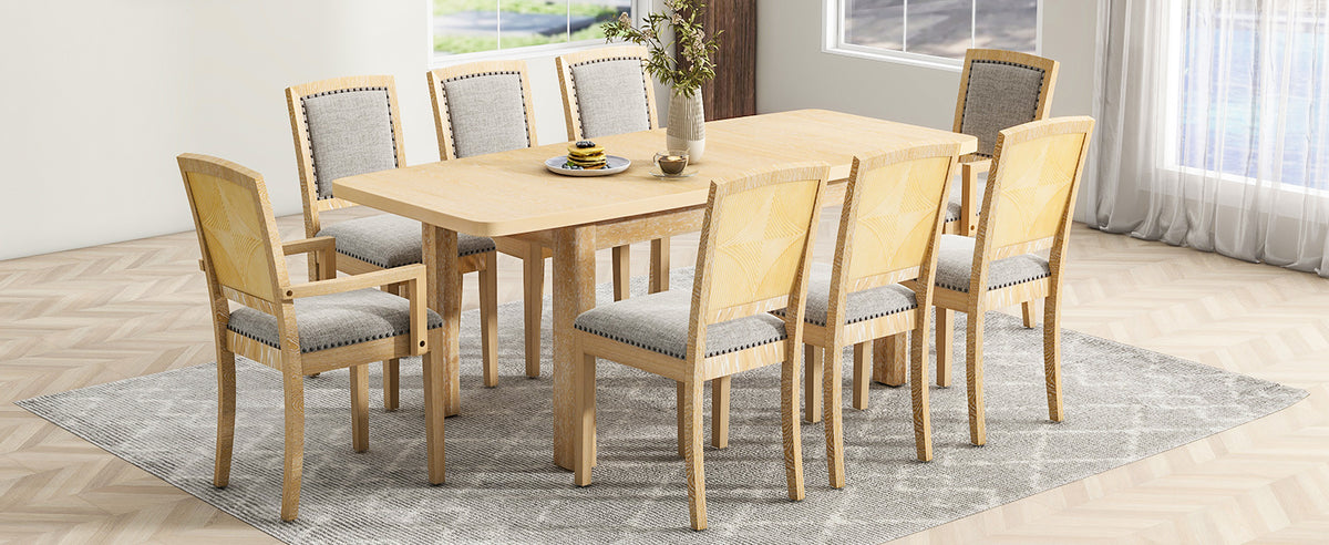 Natural wood dining table set with eight padded chairs and light-colored fabric backs
