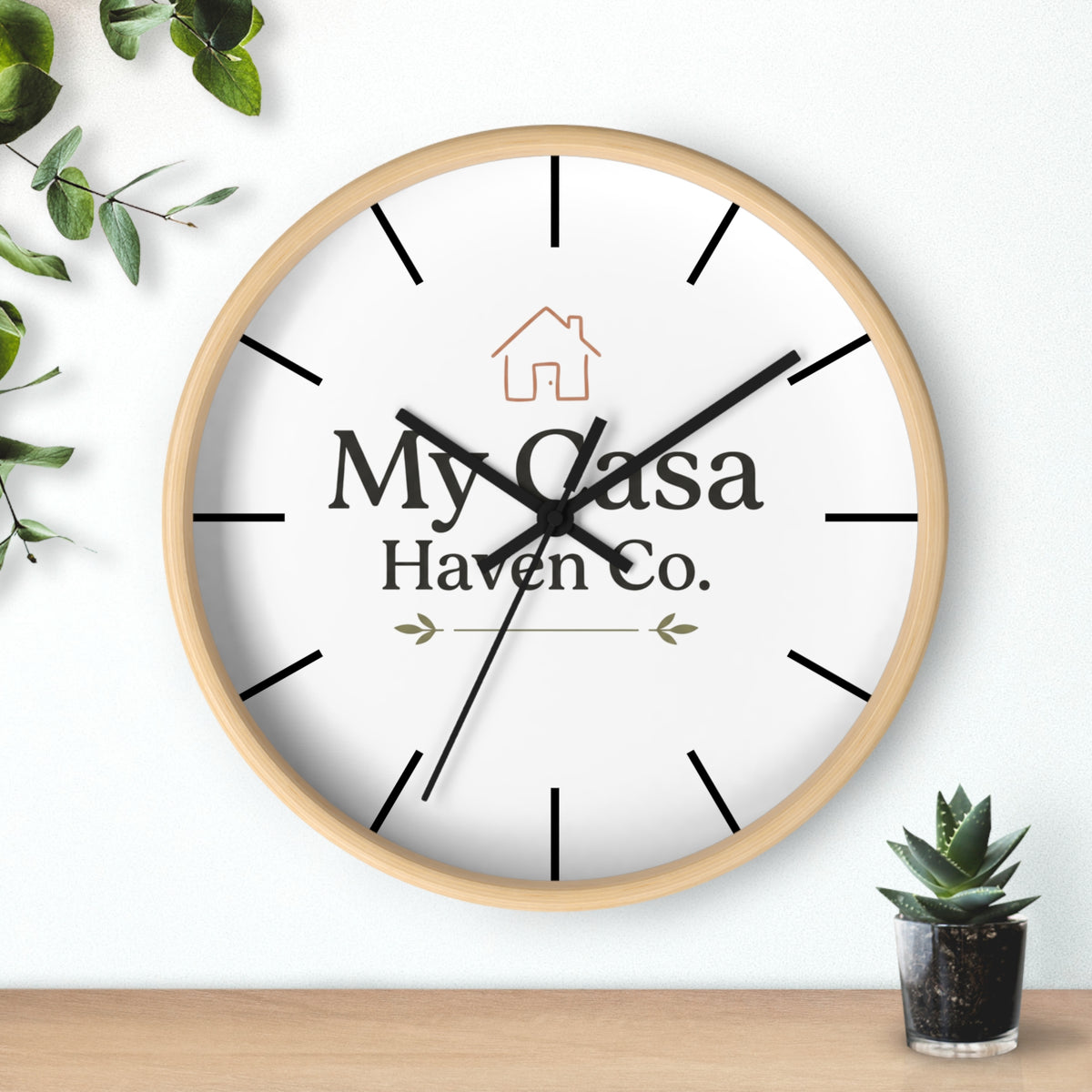 Light wood rim wall clock with white dial, black hands and black hour marks.