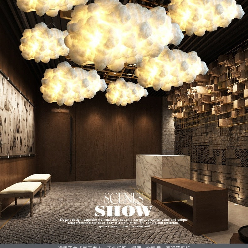 Cluster of cloud LED pendant lamps with soft warm lighting, suspended on cords