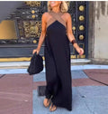 Black cross-strap maxi dress, sleeveless with crisscross back straps, side view