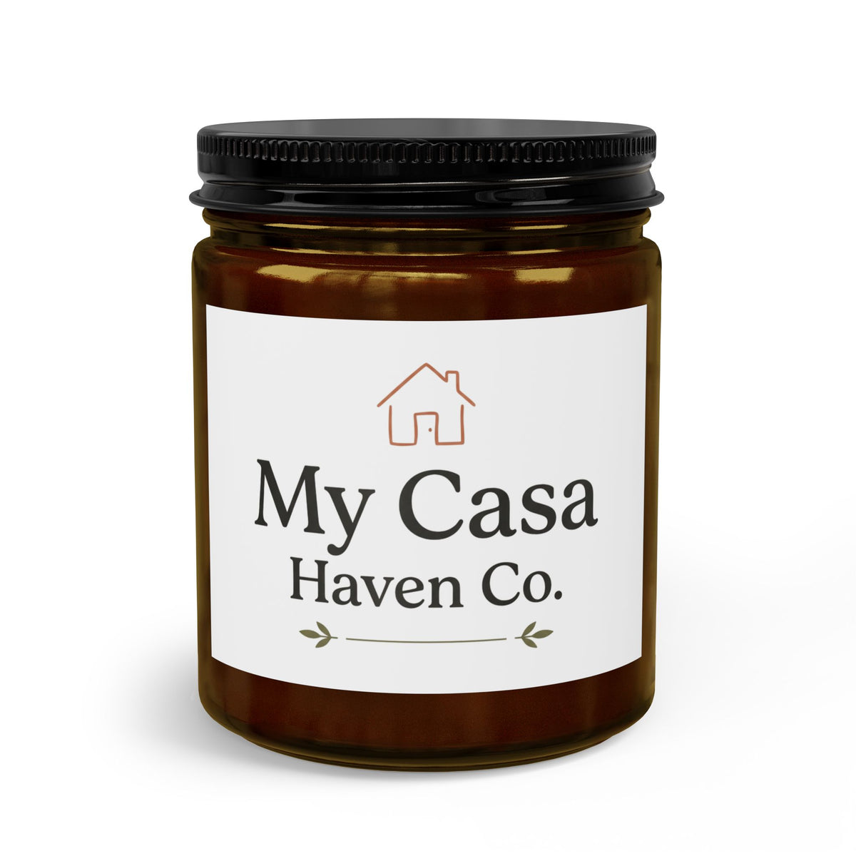Candle jar with black lid, amber wax, clear glass body and printed house logo label