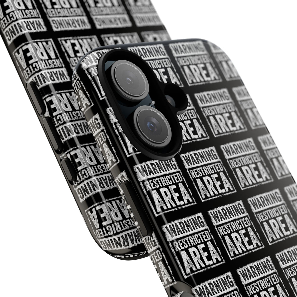 Diagonal close-up of black phone case with white 'RESTRICTED AREA' warning print