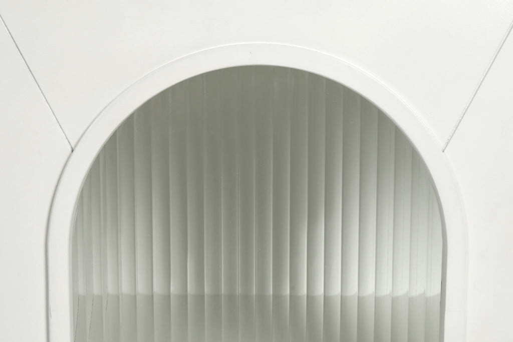 Close-up of antique white arched glass cabinet door with ribbed glass panel