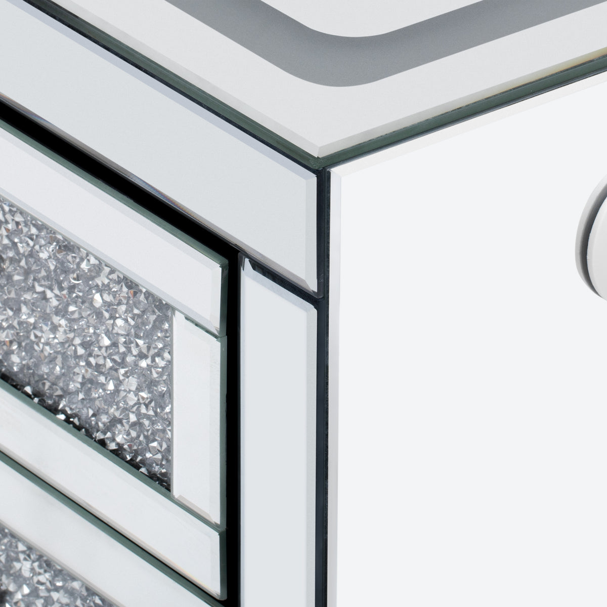 Close-up of mirror-style metal corner trim on silver coffee table edge