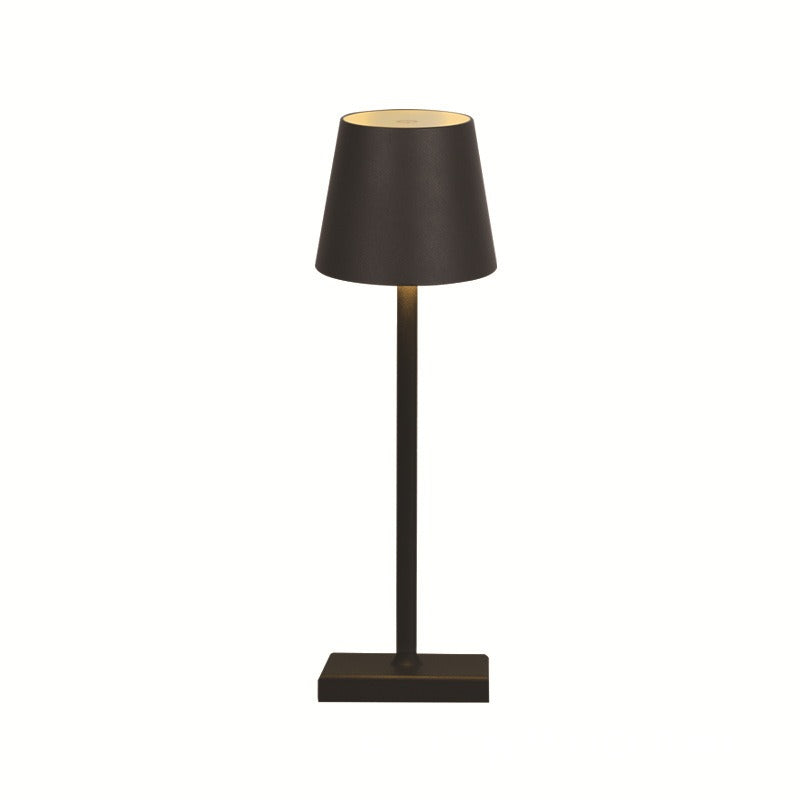 Dark retro table lamp with black drum fabric shade and slender gold stem