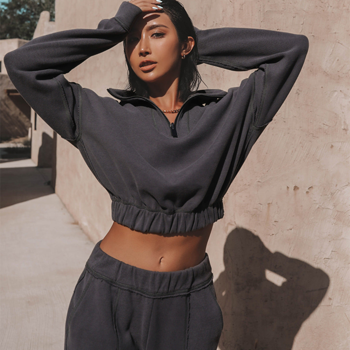 Charcoal cropped sports hoodie with half-zip and elastic hem, matching jogger pants