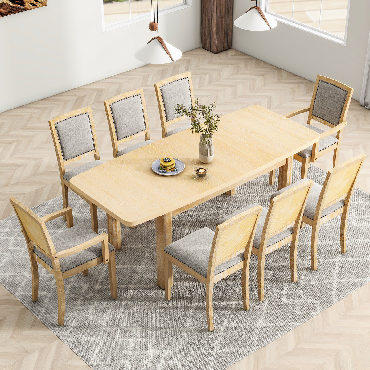 Wide dining setup with natural wood table and eight upholstered chairs around