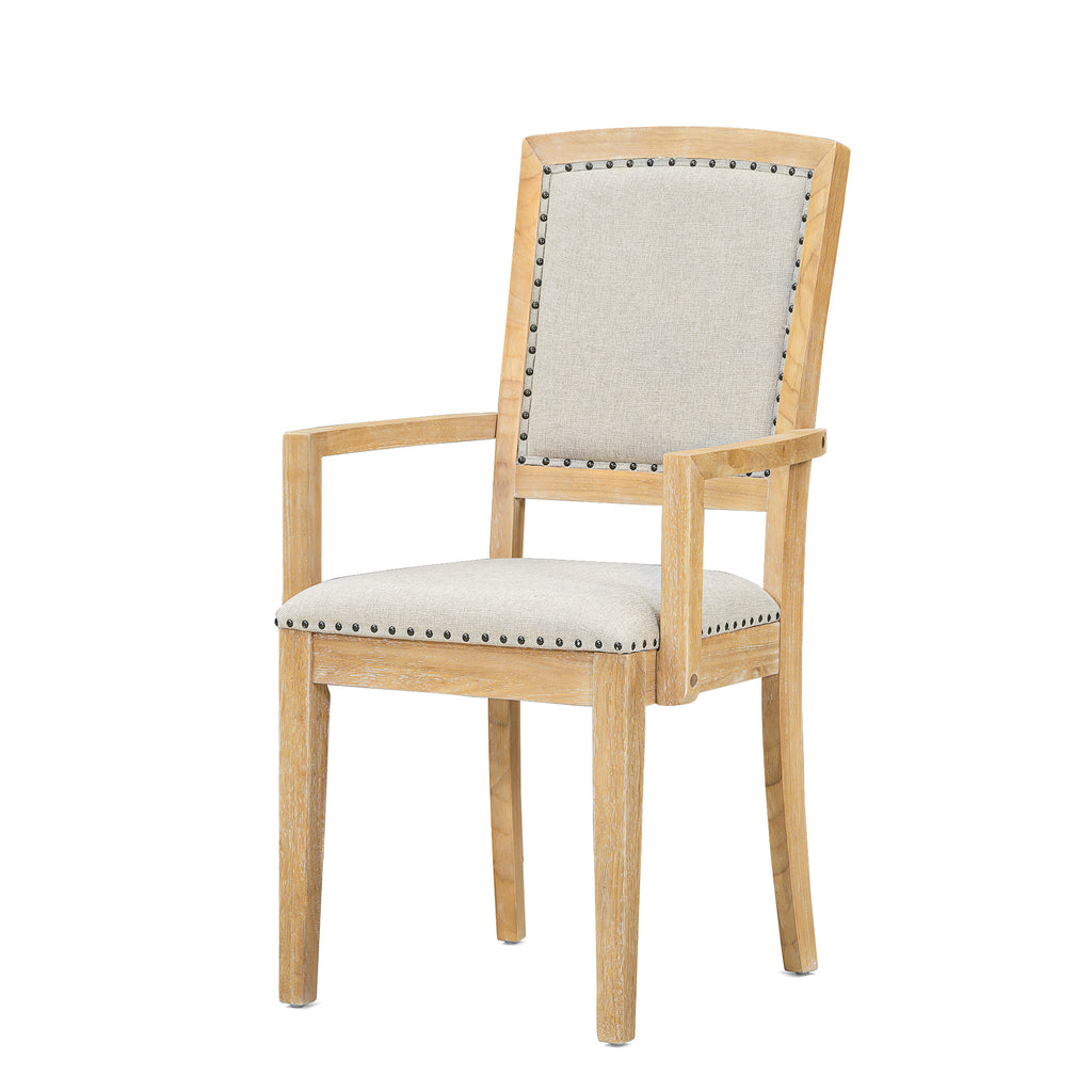 Dining chair with natural wood frame, light gray upholstery, and nailhead trim