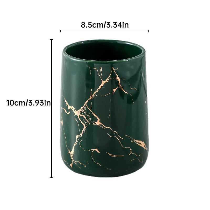 Green ceramic tumbler with golden marble veining, glossy finish, front view