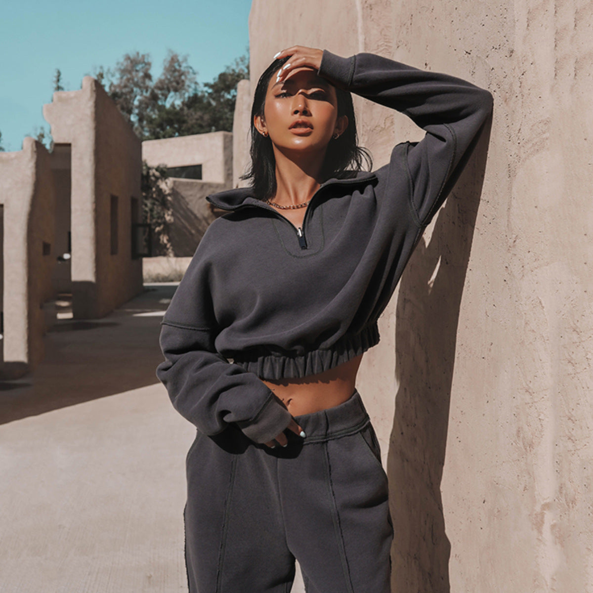 Charcoal half-zip sports hoodie and jogger set with elastic hem and matching waistband