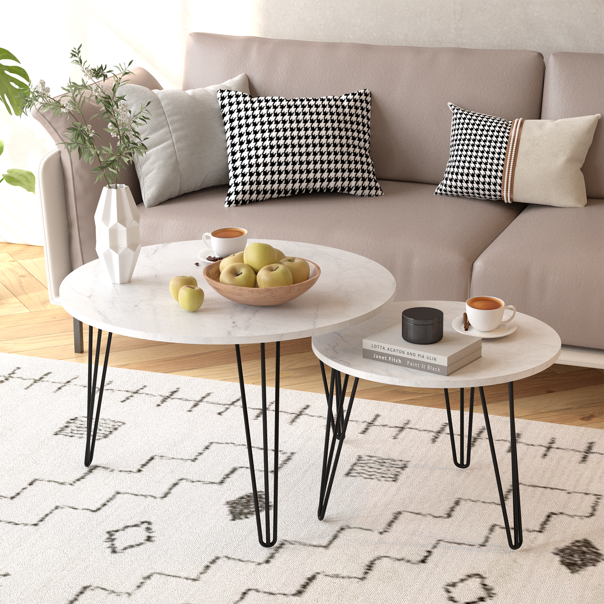 Set of 2 round nesting coffee tables with white tops and black metal legs