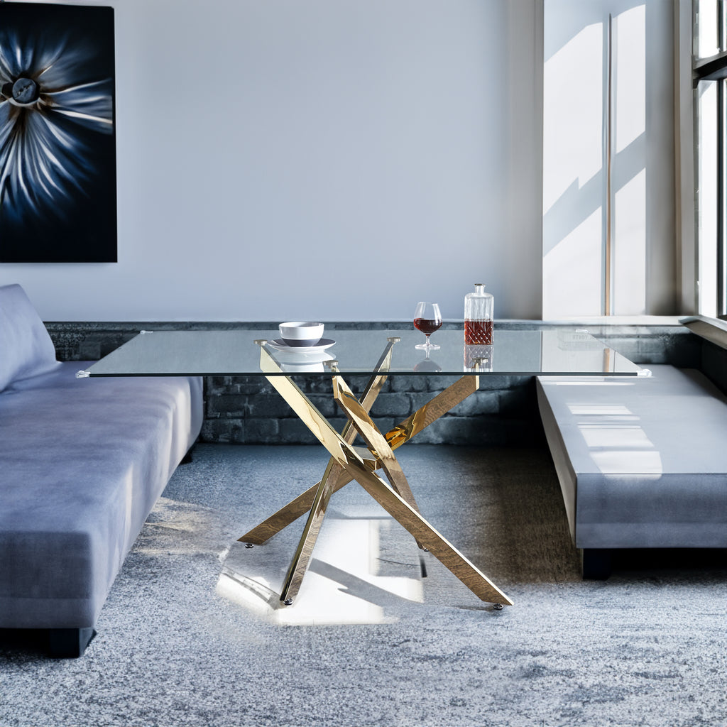 Rectangular tempered glass dining table with gold X-style base and clear glass top.