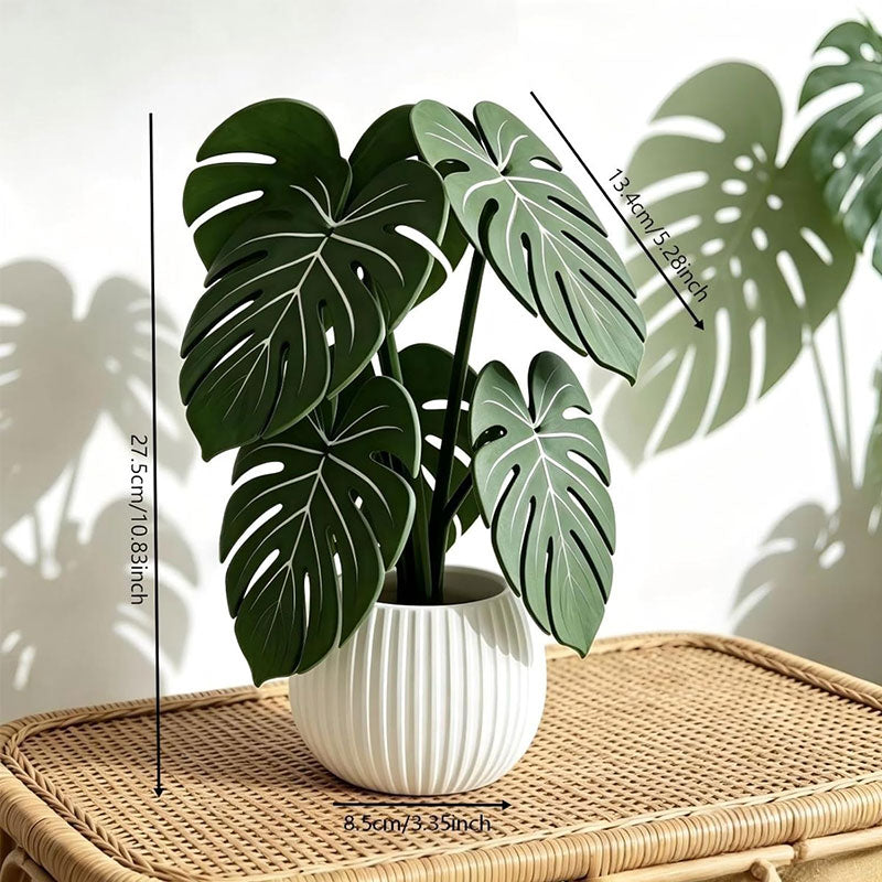 Close-up of green monstera leaf coaster under a white ribbed plant pot on a mat