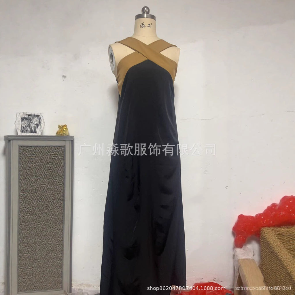 Black sleeveless maxi dress with crisscross back straps on mannequin form